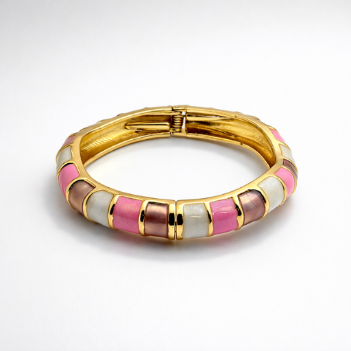 Infuse your jewelry collection with a touch of sophisticated romance. This gold-toned bangle features a harmonious blend of earthy mauve and iridescent tones, offering a refined twist on the classic enamel accessory.