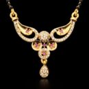 Celebrate your union with a piece that radiates regal charm and intricate artistry. This gold-toned Mangalsutra features a stunning, wing-inspired centerpiece accented by vibrant ruby-hued stones, perfectly blending traditional significance with a high-glamour aesthetic.