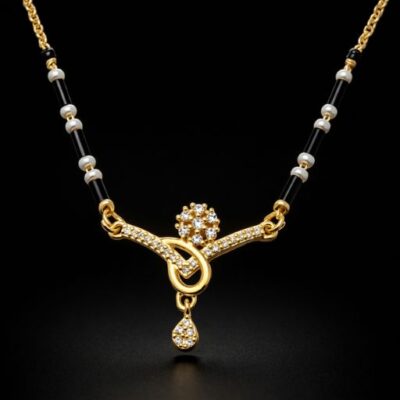 Combining intricate gold-toned craftsmanship with the timeless luster of pearls, this Mangalsutra features a stunning floral-meets-geometric centerpiece. It is a sophisticated celebration of heritage, designed for the modern woman who appreciates delicate, high-shine details.