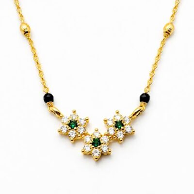 Celebrate a bond of flourishing love with this vibrant gold-toned Mangalsutra. Featuring a trio of botanical charms accented by rich green tones, this piece offers a fresh, garden-inspired take on a sacred tradition.