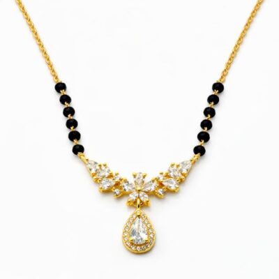 Embrace the radiance of a blooming garden with this gold-toned Mangalsutra. Featuring a graceful wing-like arrangement of marquise crystals and a stunning halo drop, it is a sophisticated tribute to tradition with a high-fashion, floral aesthetic.