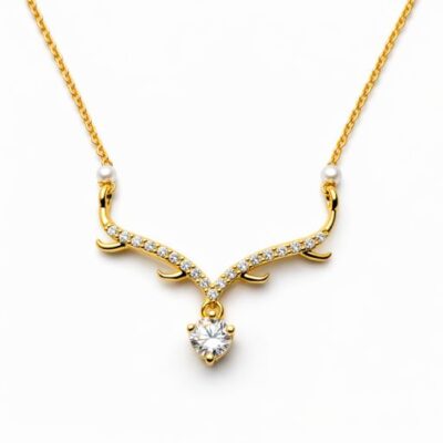 Exude a unique, nature-inspired charm with this exquisitely crafted gold-toned necklace. Blending the organic silhouette of branching antlers with the brilliance of high-clarity crystals, this piece is a sophisticated statement of grace and strength.