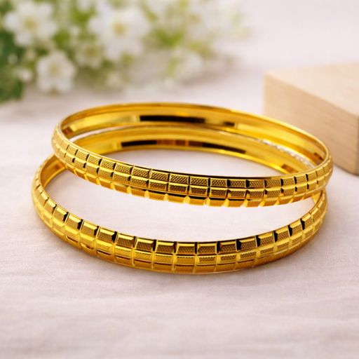 Exude a sense of refined opulence with this set of two gold-toned bangles. Featuring an intricate interplay of light and texture, these bangles are a masterclass in modern jewelry design, offering a bold yet sophisticated look that transcends seasons.