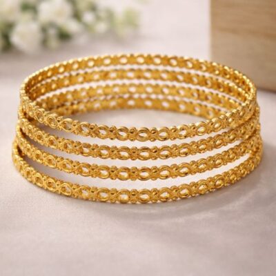 Celebrate the beauty of a continuous journey with this set of four gold-toned bangles. Featuring an intricate, openwork infinity link design, these pieces offer a masterclass in delicate metalwork, blending a timeless silhouette with a modern, airy aesthetic.