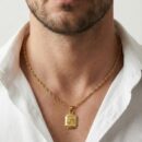 Honor the universal symbol of love and nurturing with this masterfully crafted gold-toned pendant. This piece features the sacred word "Maa" (Mother) in elegant Devanagari script, encased in a structured, high-detail frame that serves as a beautiful tribute to the maternal bond.