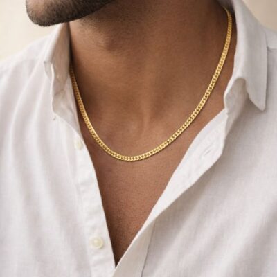 Embrace the ultimate foundation of jewelry with this impeccably crafted gold-toned curb chain. A masterclass in balance and fluid movement, this piece offers a timeless silhouette that transitions effortlessly from a bold standalone accessory to a refined carrier for your most cherished pendants.