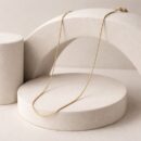 Embrace the peak of "quiet luxury" with this impeccably crafted gold-toned snake chain. Featuring a masterclass in fluid movement and high-shine surfaces, this piece offers a sleek, ultra-fine silhouette that serves as the ultimate versatile foundation for your jewelry collection.