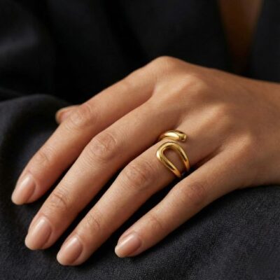 Embrace the peak of contemporary sculptural design with this impeccably crafted gold-toned open ring. Featuring a masterclass in organic fluidity and high-mirror light play, this piece offers a bold, "liquid gold" silhouette that serves as the ultimate statement of modern elegance.