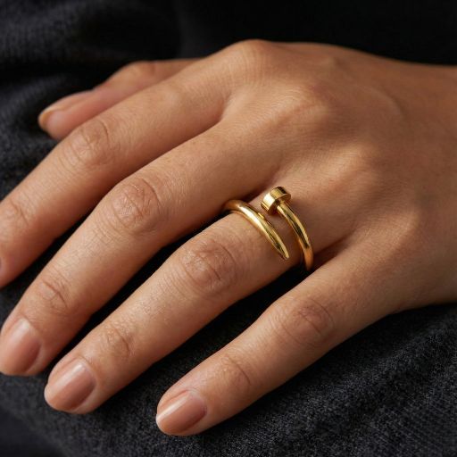 Embrace the peak of high-fashion industrial design with this impeccably crafted gold-toned open ring. Featuring a masterclass in sleek, structural lines and high-mirror light play, this piece offers a bold, "hardware-inspired" silhouette that serves as the ultimate statement of modern luxury.
