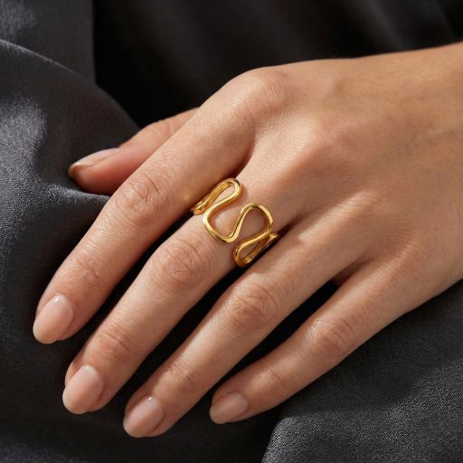 Embrace the peak of contemporary sculptural design with this impeccably crafted gold-toned open ring. Featuring a masterclass in organic fluidity and high-mirror light play, this piece offers a rhythmic, "sinuous" silhouette that serves as the ultimate statement of modern elegance.