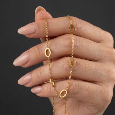 Command every room with the Gilded Pearl Bouquet Studs. These earrings showcase a magnificent multi-pearl cluster design, meticulously crafted to resemble a flourishing bouquet. Each piece features a series of high-quality, lustrous white pearls nestled within individual sculptural gold cups. The "petals" are finished with a soft, artisanal gold texture, creating a beautiful interplay of light between the iridescent pearls and the warm metallic frame. With their grand, "maximalist" profile, these studs bridge the gap between vintage high-glamour and contemporary "quiet luxury."  Key Features Lustrous Pearl Cluster: Features a grand arrangement of round pearls that radiate a soft, sophisticated glow against the skin.  Sculptural Gold Settings: Each pearl is anchored by architectural gold-toned cups that provide structural depth and a sense of organic movement.  Bold Oversized Silhouette: A large-scale, statement-making design that offers maximum visual impact while remaining balanced for all-day wear.  Premium Gold-Tone Finish: Expertly plated in rich gold for an opulent warmth and a durable, tarnish-resistant surface.  Perfect For Grand Social Occasions: An ideal hero accessory for weddings, gala events, or high-fashion garden parties.  The Modern Romantic: Perfect for someone who appreciates bold, classic jewelry that makes a statement through texture and form.  Meaningful Gifting: A magnificent and unique gift for birthdays, milestones, or anniversaries for a lover of high-concept, bridal-ready jewelry.  Style Tip These earrings are designed to be the absolute star of your look. Let their intricate bouquet profile take center stage by wearing them with a soft updo or a romantic side-sweep. Because of their rich gold and white palette, they pair exceptionally well with a neutral ensemble—think ivory silks, cream linens, or a soft beige blazer. To ensure the pearls remain the primary focus, keep your other accessories minimal—a simple gold band or a thin gold bracelet is all you need to complete this high-end aesthetic.