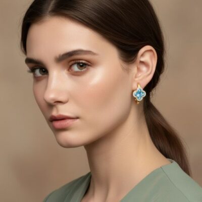 Embrace the peak of contemporary high-fashion design with these impeccably crafted gold-toned huggie earrings. Featuring a masterclass in geometric symmetry and vibrant light-play, this pair offers a sophisticated "clover" silhouette that serves as the ultimate expression of modern, playful luxury.