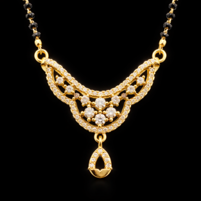 A masterpiece of intricate design and radiant sparkle, this gold-toned Mangalsutra features a stunning, web-like filigree centerpiece that offers a luxurious interpretation of a sacred classic.